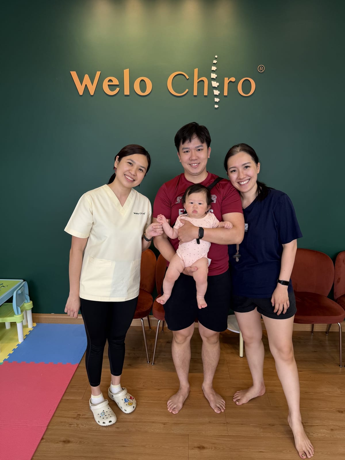 A family with their baby and the Welo Chiropractic team